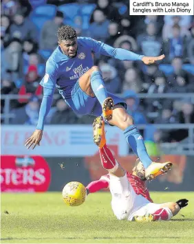  ??  ?? Cardiff’s Bruno Manga tangles with Lois Diony