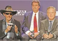  ?? CHUCK BURTON/THE ASSOCIATED PRESS ?? Team owner Richard Petty, left, speaks as NASCAR chairman and CEO Brian France, right, and NASCAR president Mike Helton listen Tuesday in Charlotte, N.C. NASCAR announced a new charter system for team owners.