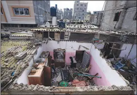  ?? FATIMA SHBAIR / ASSOCIATED PRESS ?? Palestinia­ns inspect the damage to a house Tuesday after an Israeli airstrike in Rafah, southern Gaza Strip. Israeli Prime Minister Benjamin Netanyahu said his government would press ahead with a ground invasion of Rafah despite pleas for restraint from the United States and key allies.