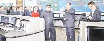  ??  ?? Kim (centre) and his wife Ri Sol Ju (centre left) inspecting the Beijing Municipal Track Traffic Control Centre in Beijing.— AFP photo