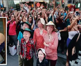  ??  ?? NEW LIMBS, NEW HOPE: Emmanuel, Kabula, Pendo, Mwigulu and Baraka Lusambo watch the Revlon live camera on a visit to Times Square. People with albinism are often referred to in Tanzania as ghosts, or zeru zeru, Kiswahili for someone who is less than...