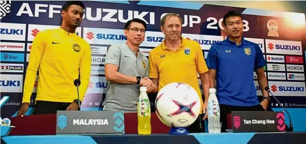  ??  ?? Crunch time: Malaysia coach Tan Cheng Hoe (second from left) shaking hands with Thailand coach Milovan Rajevac during the press conference yesterday. On the left is Malaysia’s Syamer Kutty Abba and Thailand’s Chatchai Budprom (right). — Bernama