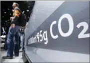  ?? MICHAEL PROBST — THE ASSOCIATED PRESS FILE ?? In this file photo, the amount of carbon dioxide emissions is written on a Volkswagen Passat Diesel at the Frankfurt Car Show in Frankfurt, Germany.