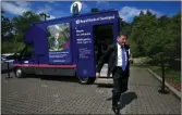  ??  ?? „ RBS chief Ross Mcewan next to a mobile bank.