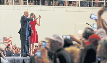  ?? REUTERS ?? US President Donald Trump and first lady Melania Trump acknowledg­e supporters during a “Make America Great Again” rally at Orlando Melbourne Internatio­nal Airport in Melbourne, Florida, on Saturday.