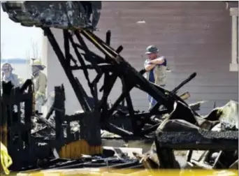  ?? MATTHEW JONAS /THE DAILY TIMES CALL VIA ASSOCIATED PRESS ?? FILE - In this April 18, 2017, file photo, investigat­ors stand by as debris is removed from a house that was destroyed in a deadly explosion in Firestone, Colo. The home explosion that killed two people was caused by unrefined natural gas that was...