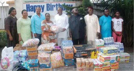  ??  ?? Celebrant, Adebowale Ogunkoya (middle) presenting some items to the founder, Heart of Gold Children Hospice in Lagos, Mrs. Lola Adedoyin, to mark his 60th birthday…recently