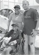  ?? WELLS DUSENBURY/SUN SENTINEL ?? Infielder Miguel Rojas poses with Marcia Cornelius and her daughter, Mornin’Star, after presenting the family with a new car. Mornin’Star is battling bone cancer.