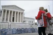  ?? STEPHANIE SCARBROUGH — THE ASSOCIATED PRESS ?? Jen Trejo holds a photo of her son Christophe­r as she is comforted outside the Supreme Court on Monday in Washington. Her son was 32 when he died and she said about Purdue Pharma and the Sackler family, “You can’t just kill my child and just pay a fine.”