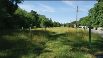  ?? SUSAN E. MIERS SMITH — MEDIANEWS GROUP ?? About 30acres along Mohrsville Road in Ontelaunee and Perry townships is being converted into a nature preserved by Berks Nature. Tree shelters that protect recently planted saplings from wildlife line a path cut in the grass.