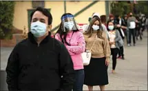  ?? JAE C. HONG / AP ?? People wait in line for COVID-19 testing at a testing site operated by CORE in Los Angeles Monday.