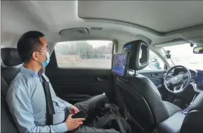  ?? PENG ZIYANG / XINHUA ?? A passenger experience­s a self-driving vehicle at Beijing Economic-Technologi­cal Developmen­t Area in Beijing on April 25, 2022.