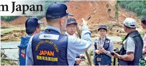  ??  ?? The Japanese team at the site of a landslide in Kosgulana, Baduraliya. Pic by Indika Handuwala