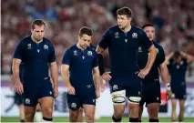  ?? GETTY IMAGES ?? Fraser Brown, Greig Laidlaw and Grant Gilchrist of Scotland walk off the pitch following defeat by Japan at the Rugby World Cup.