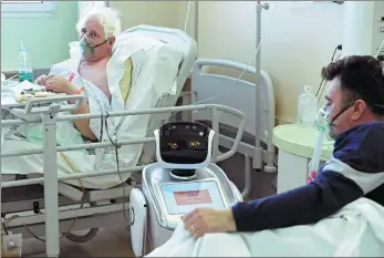  ?? FLAVIO LO SCALZO / REUTERS ?? A robot helping medical teams treat patients suffering from the novel coronaviru­s disease in the Circolo hospital, in Varese, Italy, on Wednesday.