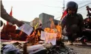  ?? Photograph: EPA ?? Protesters burn a copy of Myanmar’s constituti­on in Mandalay.