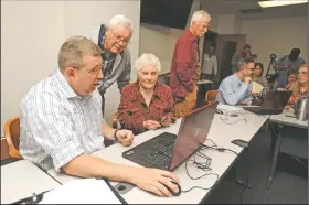  ?? NWA Democrat-Gazette/ANDY SHUPE ?? Ray and June Baggett of Fayettevil­le speak Tuesday with Lee Beshoner (left), an engineer with FTN Associates in Fayettevil­le, as they look at an updated floodplain map at the city administra­tion building.