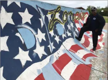  ?? RICHARD PAYERCHIN — THE MORNING JOURNAL ?? Artist Jeffery Pye of Lorain stands at the “Lorain Pride” skate ramp at Pawlak Park, at Washington Avenue and West 14th Street in Lorain. This summer Pye will touch up that work and continue painting three other sides of the two skate ramps. Local...