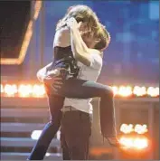  ?? J. Shearer WireImage / Getty Images ?? McADAMS AND Ryan Gosling show why they won Best Kiss for “The Notebook” at MTV Movie Awards.