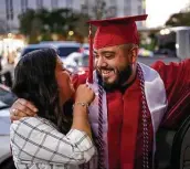  ?? Matthew Busch / Contributo­r file photo ?? Christophe­r Romero hugs his wife, Joann, at a San Antonio College graduation parade last November.