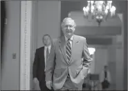  ?? AP/ANDREW HARNIK ?? Senate Majority Leader Mitch McConnell heads into the Senate chamber on Thursday. “Dealing with [the health care bill] is what’s right for the country,” he said.