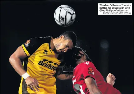 ?? LEWIS STOREY/GETTY IMAGES ?? Wrexham’s Kwame Thomas battles for possession with Giles Phillips of Aldershot