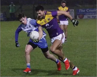  ??  ?? Glen Malone taking on Waterford’s Conor Murray as his record-equalling brother, Brian, looks on.