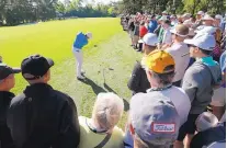  ?? CHARLIE RIEDEL/THE ASSOCIATED PRESS ?? With a large gallery surroundin­g him, Rory McIlroy hits out of the rough on the fifth hole during a practice round Tuesday in preparatio­n for the Masters in Augusta, Ga.