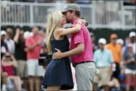  ?? LYNNE SLADKY — THE ASSOCIATED PRESS ?? Webb Simpson, right, hugs his wife Taylor Dowd Simpson, after winning the Players Championsh­ip golf tournament, Sunday in Ponte Vedra Beach, Fla.