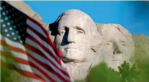  ?? —AP ?? The sun rises on Mount Rushmore National Memorial near Keystone.