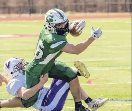  ?? James Franco / Special to the Times Union ?? Greenwich running back Max Maguire is tackled by Voorheesvi­lle defender Aidan Strauss on Sunday. Maguire had 155 yards rushing.