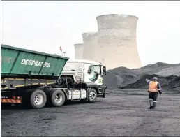  ??  ?? A worker oversees a truck delivering coal supplies to Grootvlei power station, which is operated by Eskom. Renewable energy is viewed as a major threat to jobs in mining and transport.