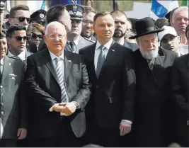  ?? Czarek Sokolowski ?? The Associated Press Polish President Andrzej Duda, center right, and Israeli President Reuven Rivlin, center left, walk Thursday in the March of the Living, a yearly Holocaust remembranc­e march between the former Nazi death camps of Auschwitz and...