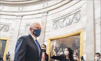  ?? Amanda Voisard / Washington Post News Service ?? Vice President Mike Pence heads through the Capitol Rotunda into the House chamber for the electoral college count on Jan. 6.