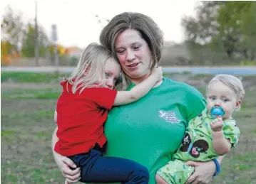  ?? ASSOCIATED PRESS FILE PHOTO ?? Courtney Kemp Robertson, 27, holds her daughters Kaylee Kemp, 3, left, and Madisson Kemp, 9 months, in Jonesville. Courtney’s husband Roy Wyatt Kemp, 27, died in the Deepwater Horizon oil rig explosion.