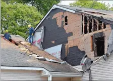  ?? SARAH GORDON/THE DAY ?? Employees with ServiceMas­ter inspect damage Thursday at Brookside Village Apartments. One person was taken to the hospital and 21 people were displaced by a fire Thursday morning at a multi-family building for the elderly and disabled in Pawcatuck.