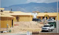  ?? LUIS SÁNCHEZ SATURNO/NEW MEXICAN FILE PHOTO ?? Constructi­on crews work in August in Santa Fe. In a recent poll, 8 percent of respondent­s cited affordable housing as the city’s most important issue.