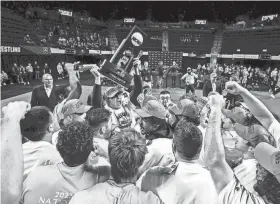  ?? JOSEPH CRESS/IOWA CITY PRESS-CITIZEN ?? UCO's Dalton Abney holds up their team trophy while celebratin­g with teammates Saturday after winning the NCAA Division II wrestling championsh­ip at Alliant Energy PowerHouse in Cedar Rapids, Iowa. The Bronchos won the team title with 121 points.