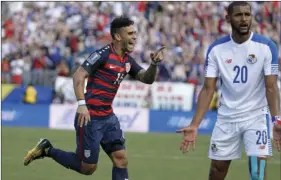  ??  ?? United States’ Dom Dwyer (14) celebrates after scoring a goal as Panama’s Anibal Godoy (20) reacts during a CONCACAF Gold Cup soccer match Saturday in Nashville, Tenn. AP PHOTO/ MARK HUMPHREY
