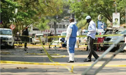  ?? ?? Police killed five people as investigat­ors carry out inspection­s at the scene of a bomb blast in Parliament­ary Avenue, Kampala. Photograph: Xinhua/REX/Shuttersto­ck