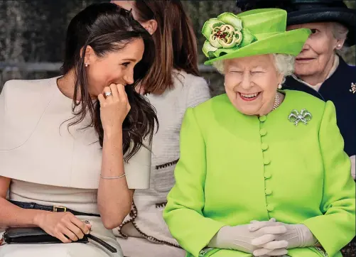  ??  ?? Royal rapport: The Queen is tickled by a comment from the Duchess of Sussex on a visit to Widnes, Cheshire, yesterday