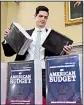  ?? AP/SUSAN WALSH ?? James Knable helps to unpack copies Monday of the President’s FY19 Budget after it arrived at the House Budget Committee office on Capitol Hill.