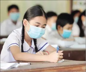  ?? HENG CHIVOAN ?? A student studies in her classroom at Tuol Tompoung Secondary School in Phnom Penh’s Chamkarmon district.