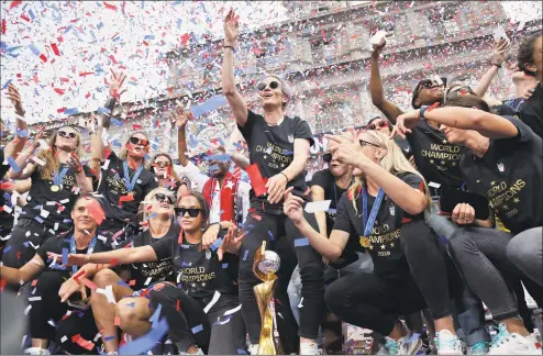  ?? Seth Wenig / Associated Press ?? The U.S. women’s soccer team and Megan Rapinoe, center, celebrate at City Hall after a ticker tape parade, on Wednesday in New York.