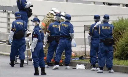  ?? Photograph: KYODO/Reuters ?? Police officers investigat­e the site near Japanese prime minster Fumio Kishida’s official residence where a man protesting a state funeral for Shinzo Abe set himself on fire.