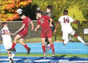  ?? PETE BANNAN — DIGITAL FIRST MEDIA ?? West Chester Henderson Aiden McFadden (10) and Tom Kelly try to head the ball against Conestoga on Saturday.