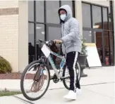  ?? PAT NABONG/ SUN- TIMES PHOTOS ?? Lorenzo Matthews, who was wounded in a barbershop shooting in January, walks a new bike he received Saturday.