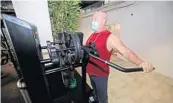  ??  ?? A patron works out with a mask at Powerhouse Gym in Fort Lauderdale on July 28.