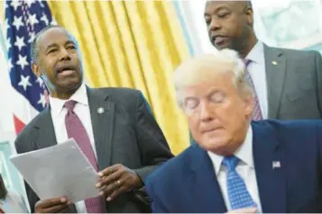  ?? MANDEL NGAN/GETTY ?? Dr. Ben Carson, left, appears with then-President Donald Trump in the Oval Office in June 2019, when Carson was secretary of Housing and Urban Developmen­t. Trump should pick Carson as his running mate in the 2024 presidenti­al election, writes Matthew Beers.