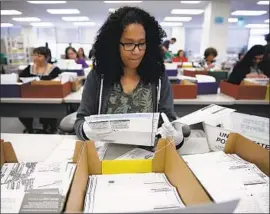  ?? Patrick T. Fallon For The Times ?? MAIL-IN BALLOTS are sorted Wednesday at the L.A. County registrar’s office. With nearly 5 million votes uncounted statewide, some races are still undecided.